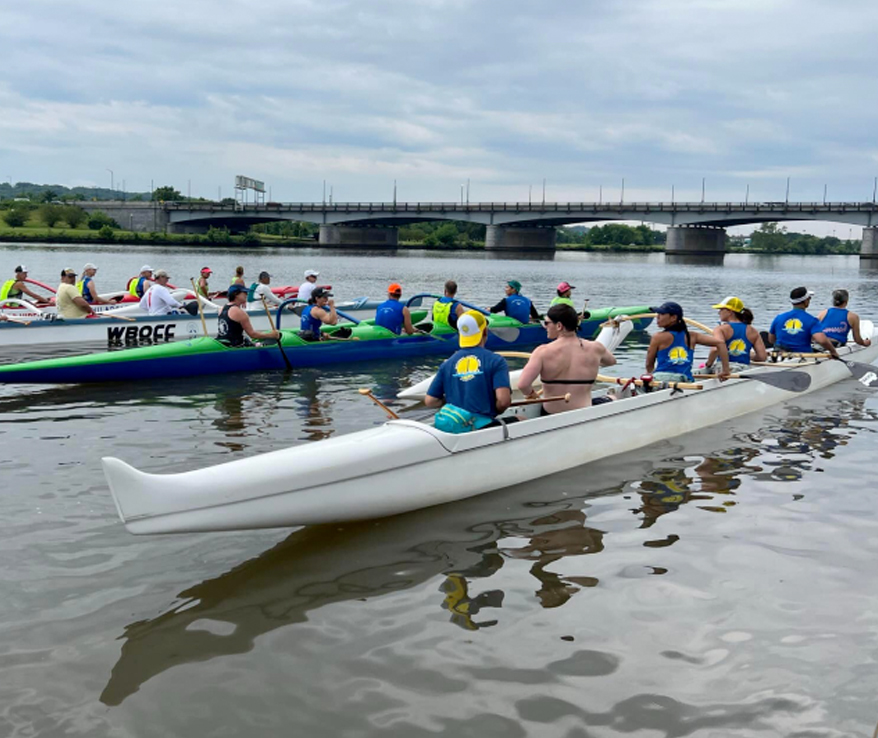 Photo of several canoes getting ready to race