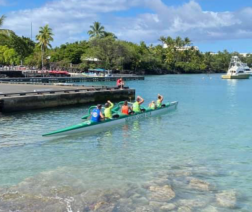 Photo of people rowing in a canoe